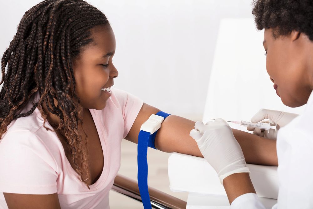 a young girl getting blood drawn for blood test