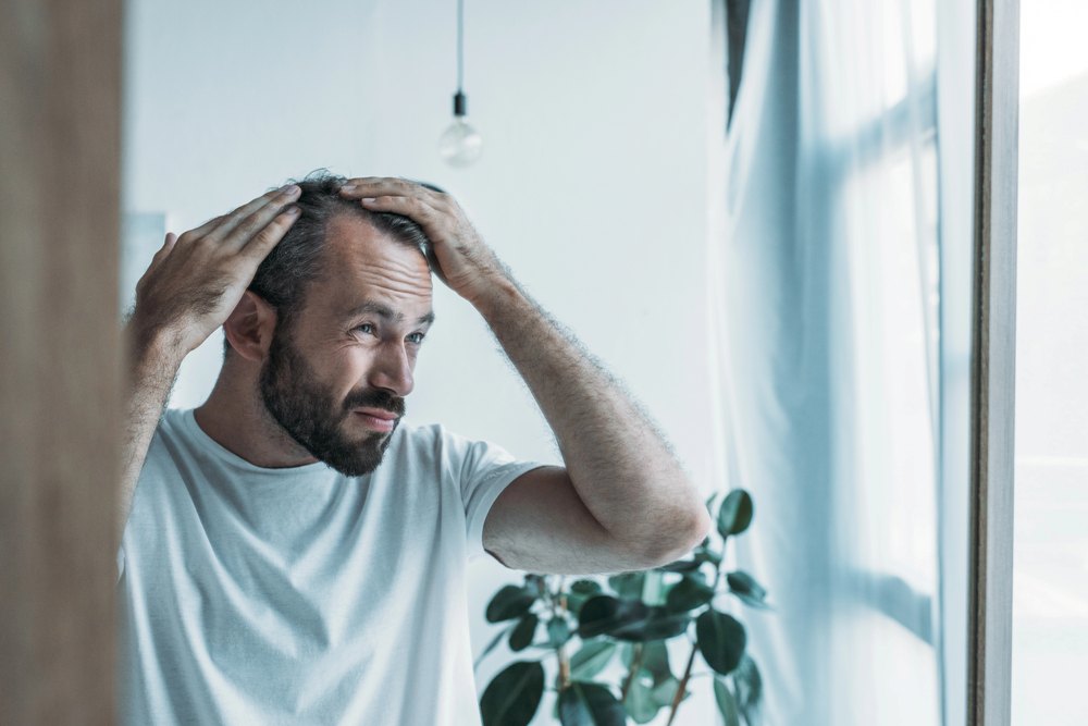 a man checking his hair loss problem