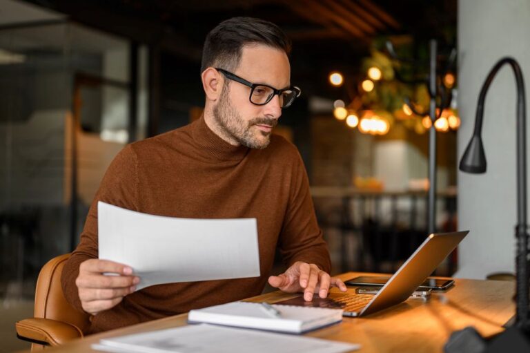 a man holding an online referral letter